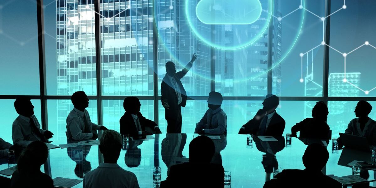 Executive team in a modern boardroom reviewing Cloud ERP Benefits, with a digital cloud icon and data connections illustrating real-time financial visibility, scalability, and secure cloud-based business management.