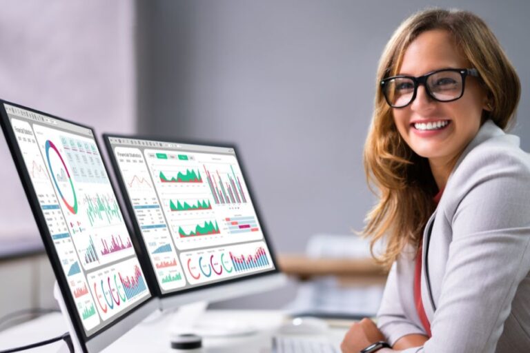 Professional reviewing Microsoft Dynamics 365 Business Central Analytics dashboards displaying real-time financial and operational data visualizations for business performance analysis.