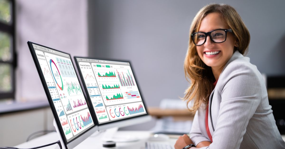 Professional reviewing Microsoft Dynamics 365 Business Central Analytics dashboards displaying real-time financial and operational data visualizations for business performance analysis.